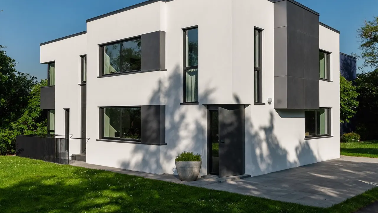 Anthracite grey front door flanked by matching grey windows on a brick porch