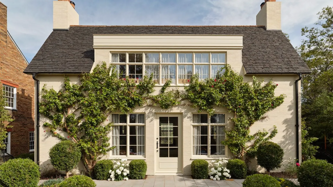 Cream flush casement windows on a rendered period cottage exterior