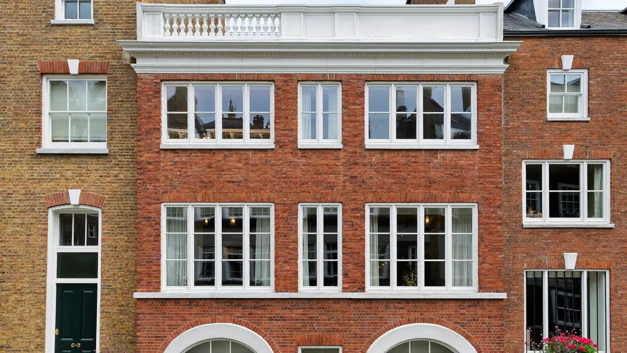 Georgian townhouse with tall white sash windows and glazing bars