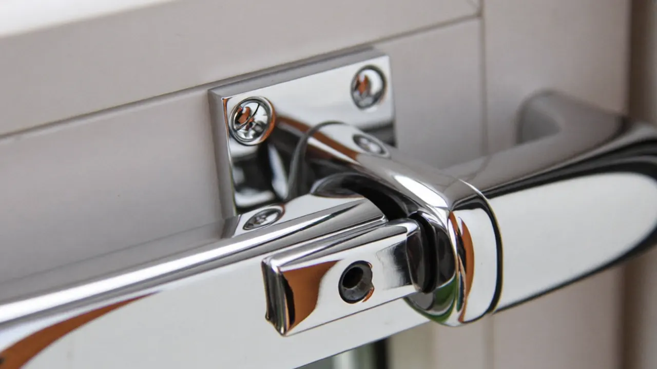Close-up of a tilt and turn window handle showing the two operating positions