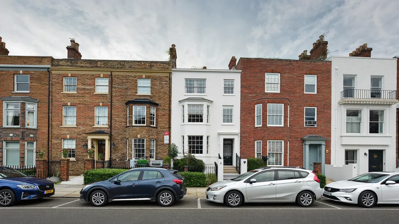 A UK residential street showing a mix of terraced, semi-detached and modern homes